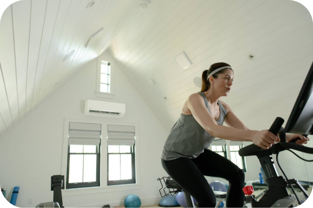 woman-in-home-gym-highwall2-modified | Carrier Ductless